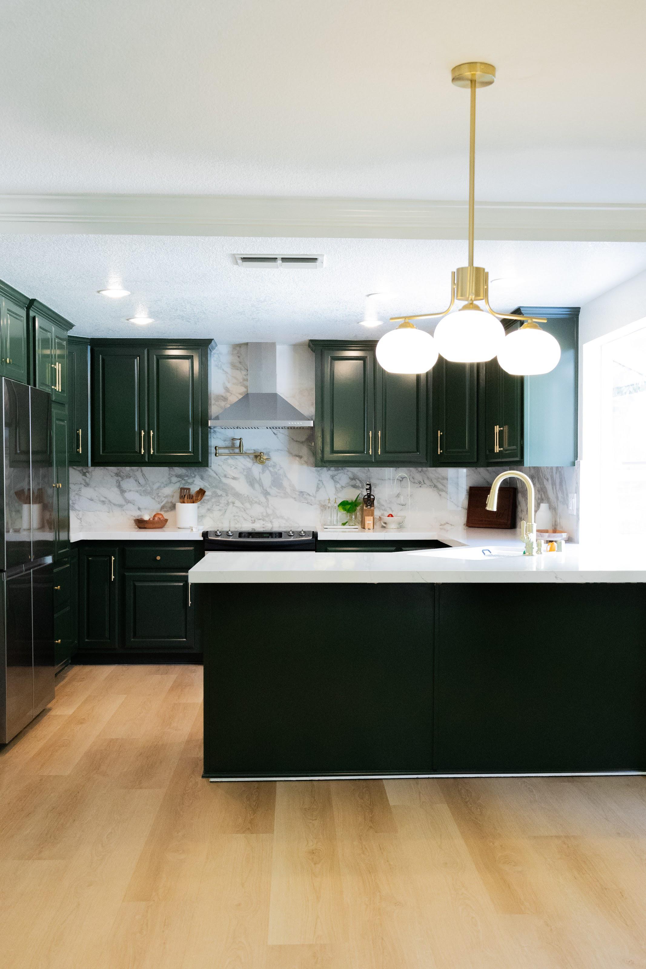 Modern kitchen remodel with dark cabinetry and marble finish